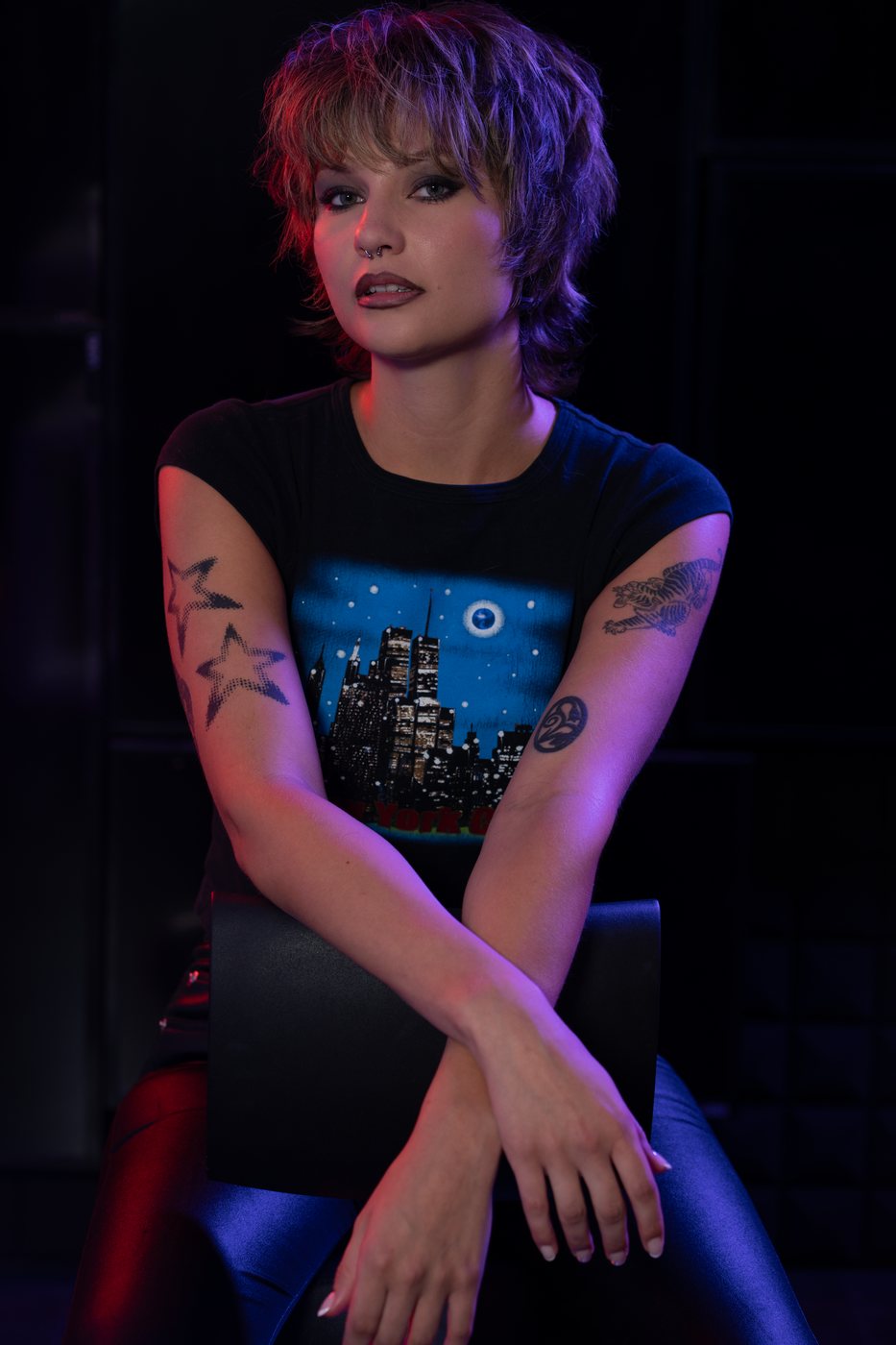 Bold editorial lip and colored studio lighting - seated portrait