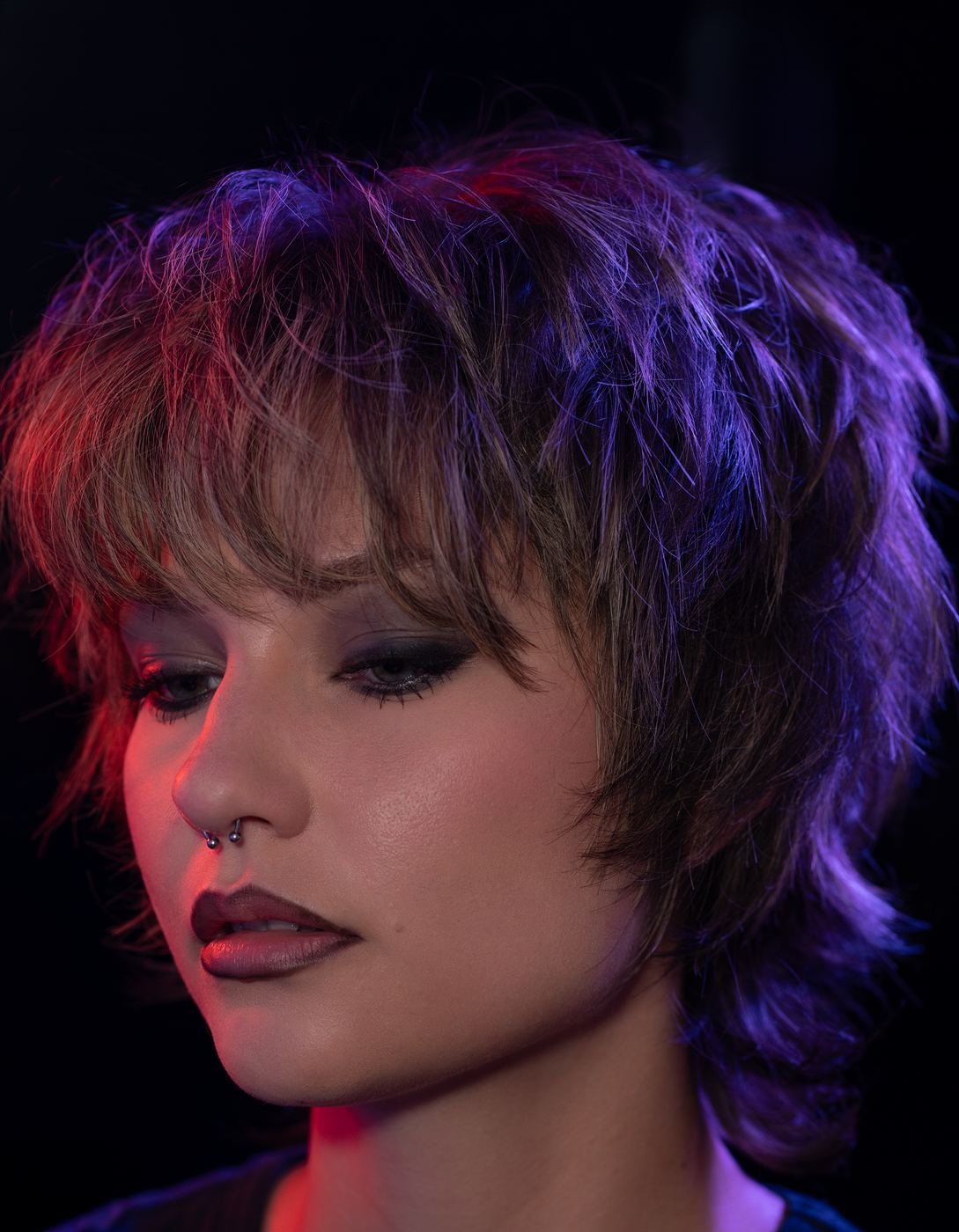 Smokey eye beauty close-up under red and purple gel lighting